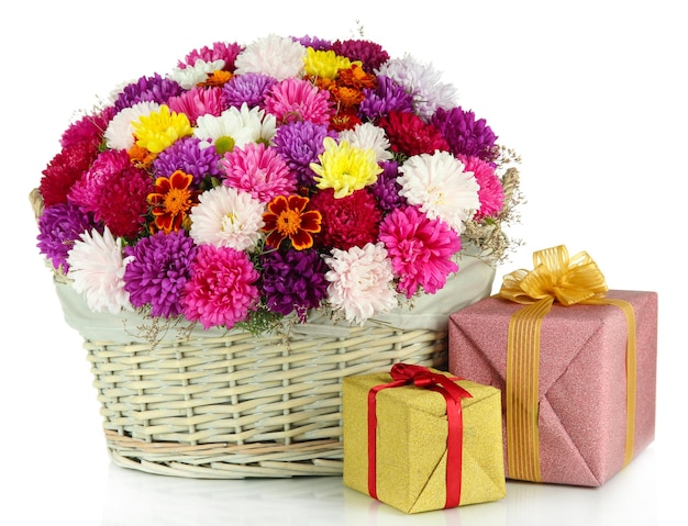 Beautiful bouquet of chrysanthemums in wicker basket isolated on white