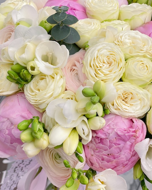 A beautiful bouquet of delicate flowers. White roses combined with pink peonies, ranunculus and spring freesia.