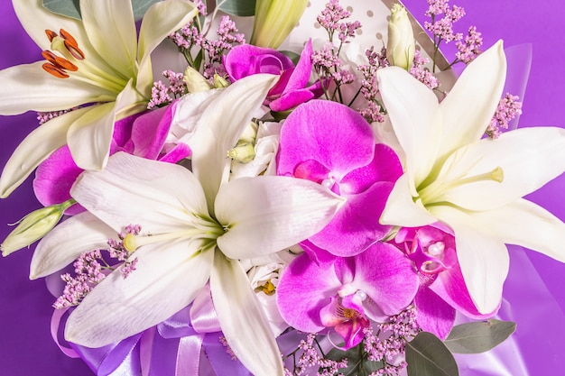 A beautiful bouquet of fresh flowers on a violet background