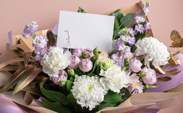 Beautiful bouquet of mixed flowers with blank greeting card