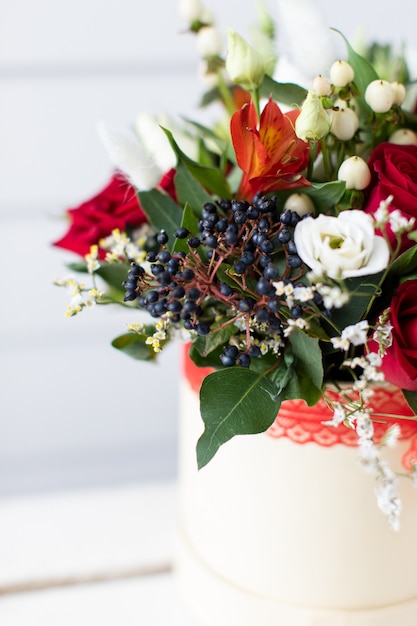 Beautiful bouquet of mixed flowers with peonies. The work of the florist. Flower delivery