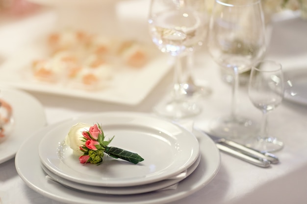 Beautiful boutonniere lies on a white plate