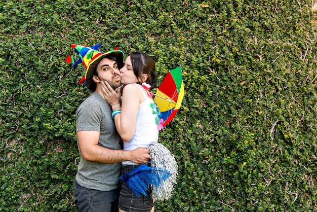 Beautiful Brazilian couple kissing at carnival party