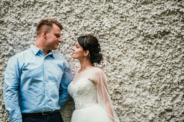 Beautiful bride and groom hugging and kissing on their wedding day