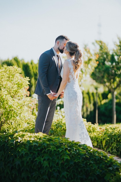 Beautiful bride and groom kissing in the garden