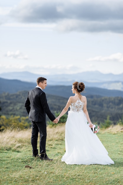 Beautiful bride and groom at the mountains