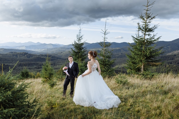 Beautiful bride and groom at the mountains