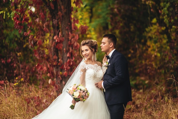 Beautiful bride and groom outdoors in the woods