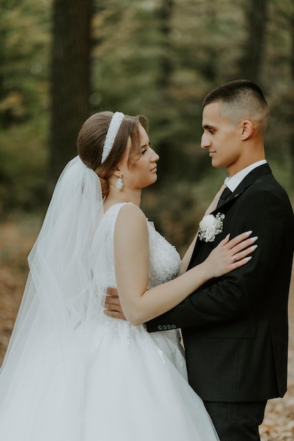 Beautiful bride and groom at sunset in green nature.