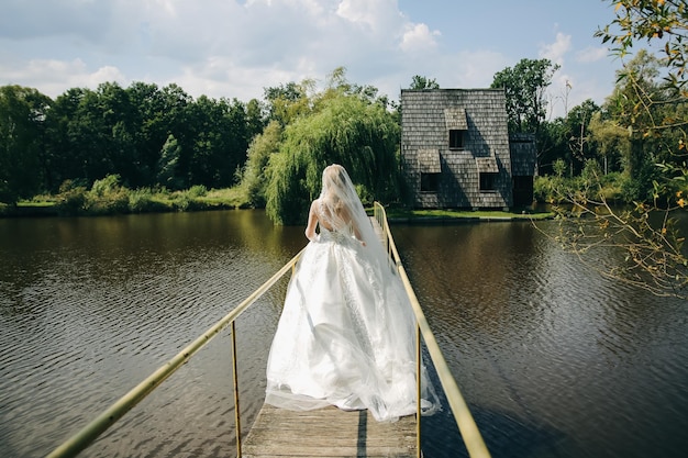 Beautiful bride is walking on the bridge Wedding photo outdoors