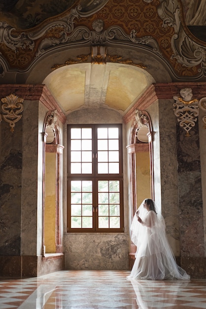 Beautiful bride in luxury baroque interior castel.