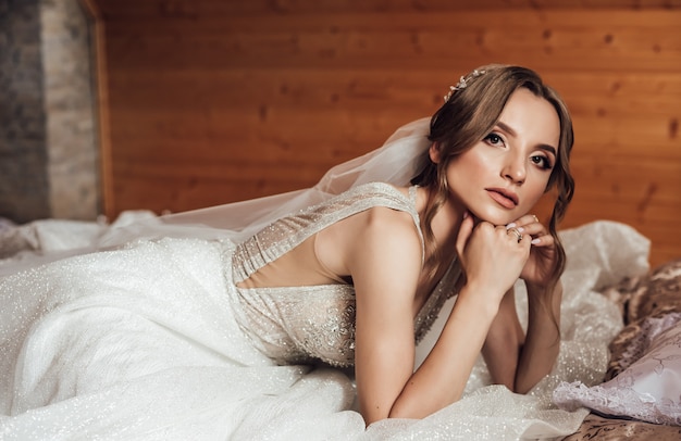 Beautiful bride portrait with veil over her face. Close Up portrait of young gorgeous bride. Wedding.