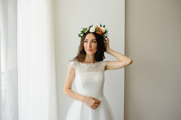 Beautiful bride tries on a wreath on her head.