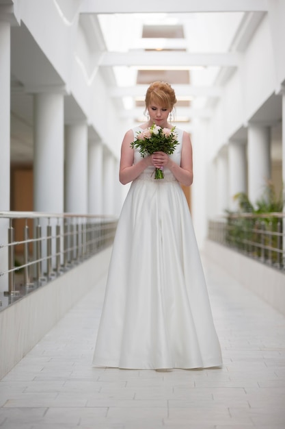 Beautiful bride with a bouquet in the hallway The girl in the registry office