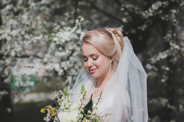 Beautiful bride with fashion wedding hairstyle outdoors. Portrait of young gorgeous bride. Wedding.