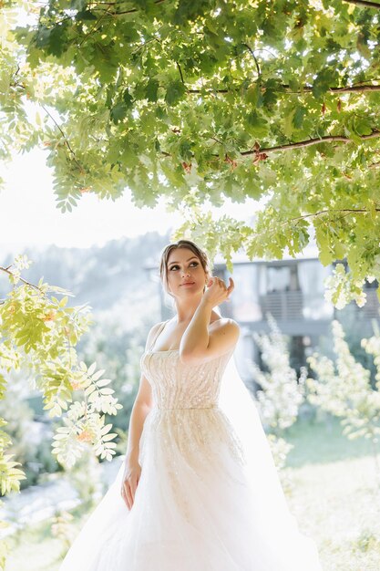 Beautiful bride with wedding flowers bouquet attractive woman in wedding dress Happy newlywed woman Bride with wedding makeup and hairstyle Smiling bride Wedding day Gorgeous bride Marriage