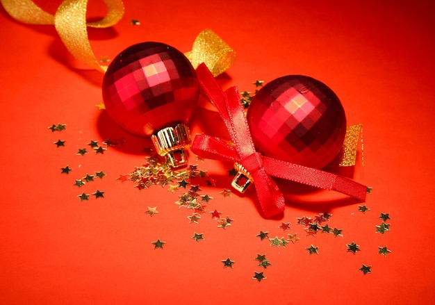 Beautiful bright Christmas balls on red wall