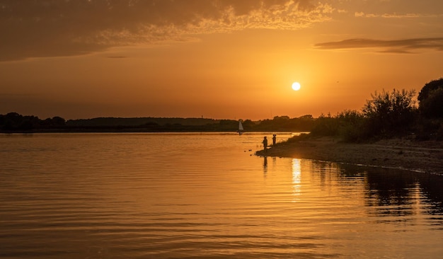 Beautiful bright dramatic sunset over the river