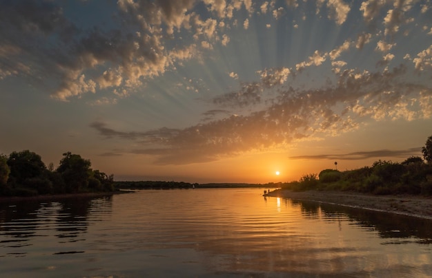 Beautiful bright dramatic sunset over the river