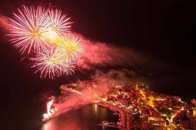 Beautiful bright fireworks in the night sky above the city