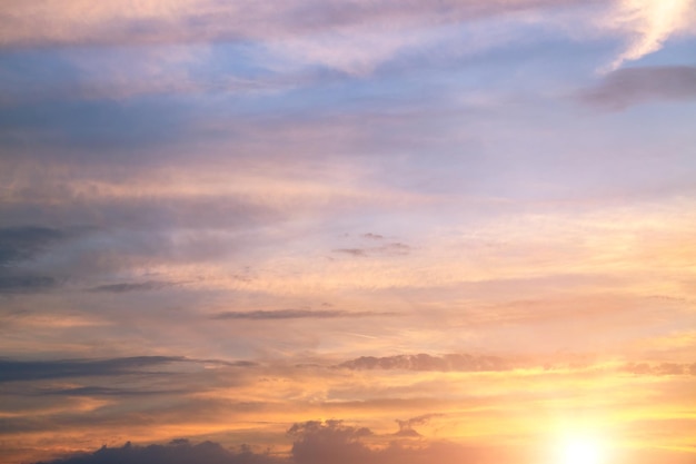 Beautiful bright sunset on the sky sky with clouds in the evening