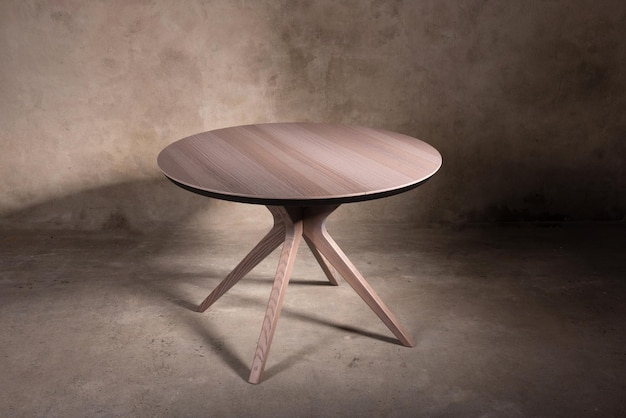 Beautiful brown wooden folding table on beige concrete background. Beautiful furniture in a modern interior