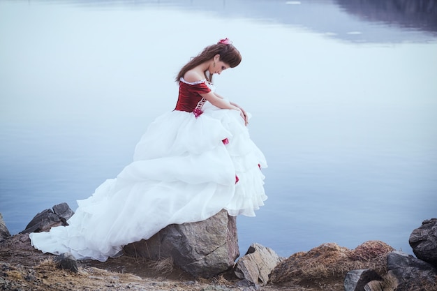 Beautiful brunette in a dress with cello