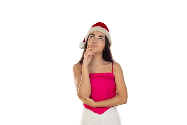 Beautiful brunette girl in santa claus hat isolated on white background with copy space