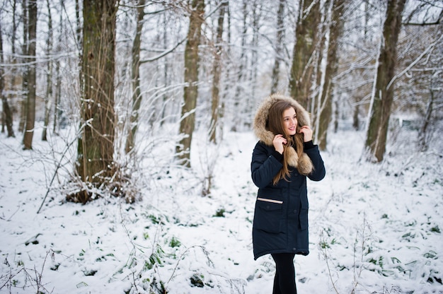 Beautiful brunette girl in winter warm clothing. Model on winter jacket.