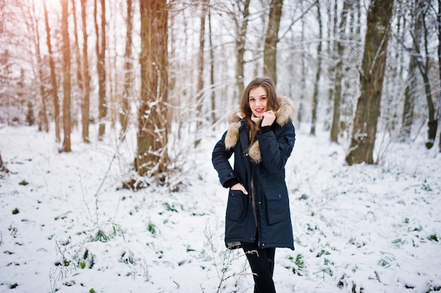 Beautiful brunette girl in winter warm clothing. Model on winter jacket.