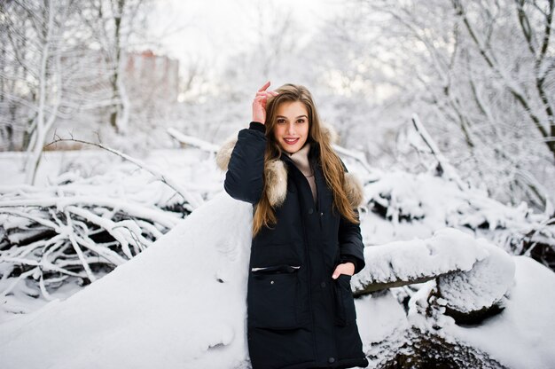 Beautiful brunette girl in winter warm clothing. Model on winter jacket.