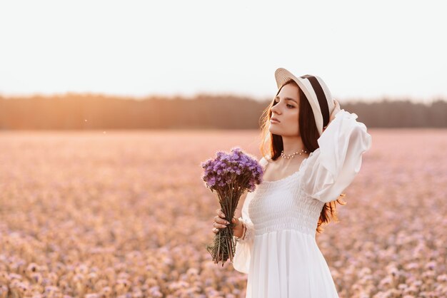 Beautiful brunette in a lavender field at sunset Amazing Portrait