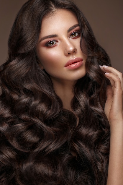 Beautiful brunette model: curls, classic makeup and full lips, The beauty face,