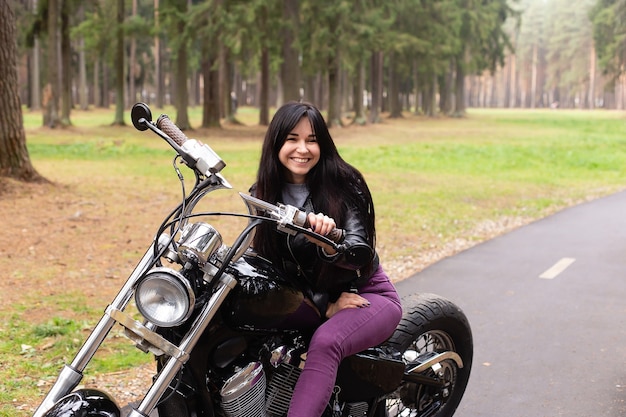 The beautiful brunette on a motorcycle