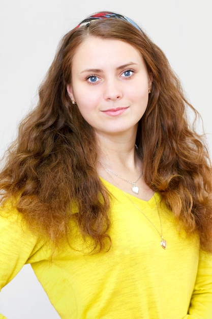 Beautiful brunette smiling girl with long red hair