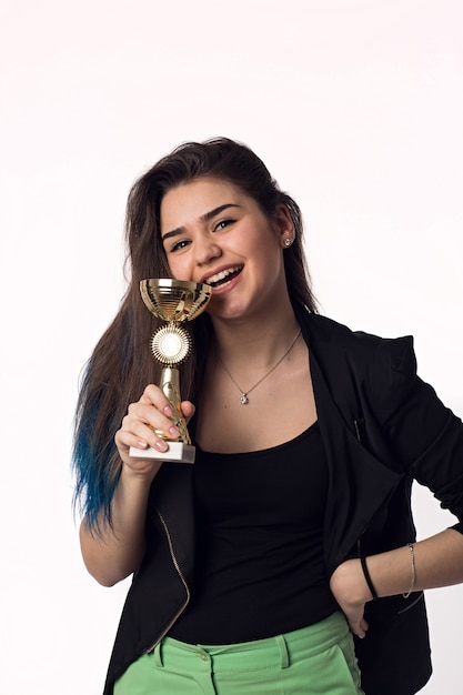 Beautiful brunette student young woman in black jacket with goblet