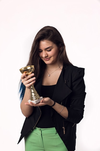 Beautiful brunette student young woman in black jacket with goblet