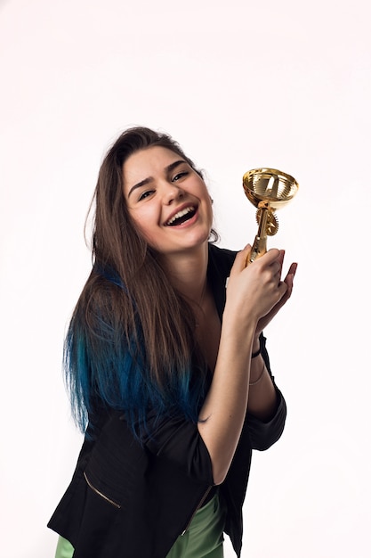 Beautiful brunette student young woman in black jacket with goblet