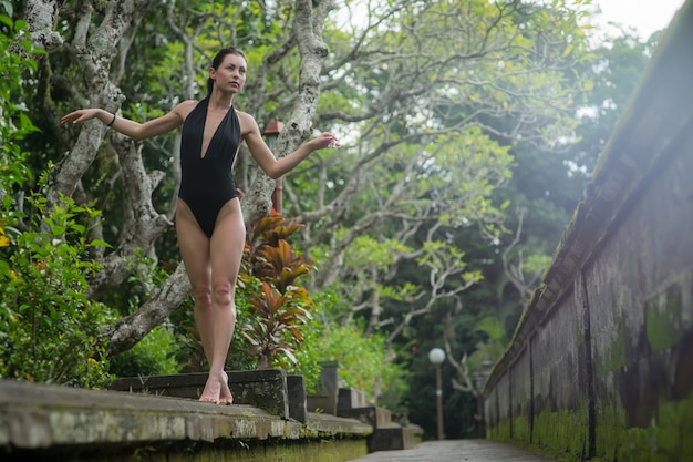 Beautiful brunette woman with perfect body in swimsuit in the Bali. Indonesia