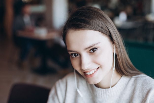 Beautiful brunette young woman in a cafe