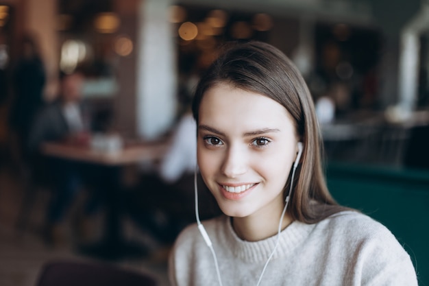 Beautiful brunette young woman in a cafe