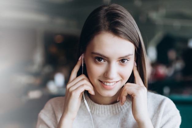 Beautiful brunette young woman in a cafe