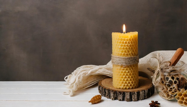 Beautiful burning beeswax candle and decoration on wooden table