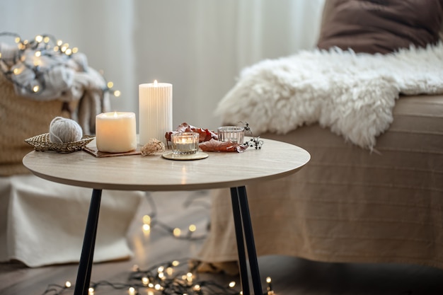 Beautiful burning candles in the interior of a room in a Scandinavian style.