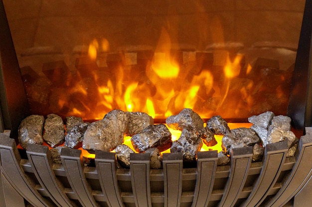 Beautiful burning fireplace with grate closeup