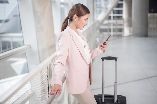 Beautiful business woman is walking in Airport, Business travel concept 