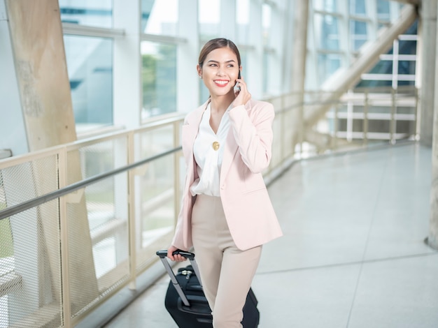 Beautiful business woman is walking in Airport, Business travel concept 