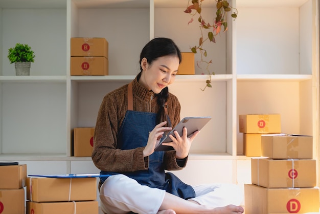 Beautiful business woman owner selling online using tablet to chat with customer.