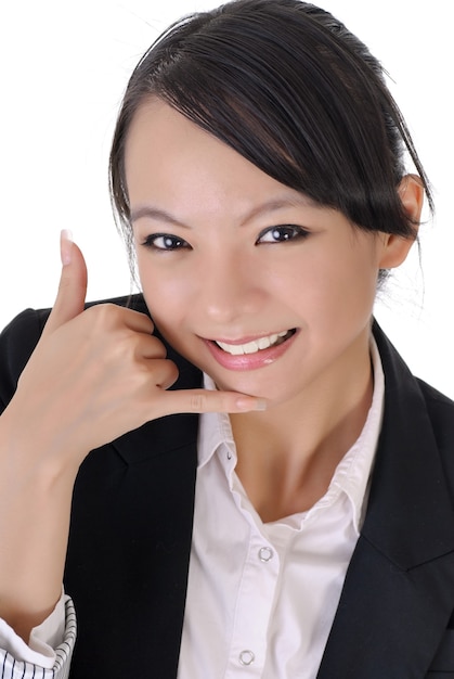 Beautiful business woman showing telephone gesture to ask you to call her.