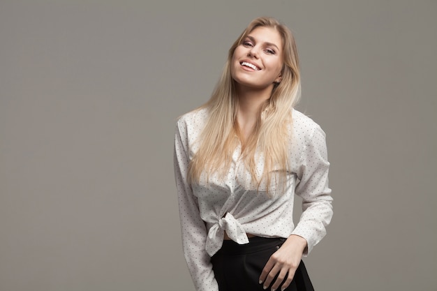 Beautiful Business Woman smiling on grey